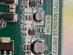 Close-up of a Printed Circuit Board with Components Close-up of a printed circuit board with electronic components, including integrated circuits and coils.
