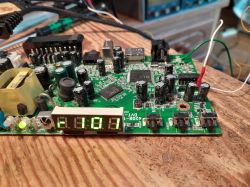 Close-up of a PCB with an LED display showing r101 and connected wires.