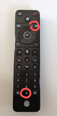 Remote control with red circles around the TV and 0 buttons.