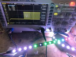 Rigol DS1054Z oscilloscope displaying a signal and a WS2812B LED strip.