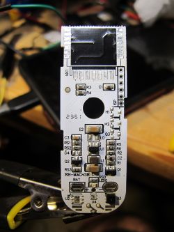 Image of a white PCB TH01 with electronic components and a micro USB port.