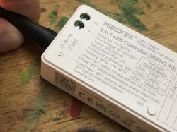 Miboxer 3 in 1 LED controller on a wooden table.