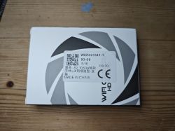 Box of a 1080p WiFi HD surveillance device Box with WiFi HD device label lying on a wooden surface