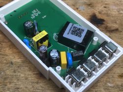 Interior of Sonoff energy meter with visible PCB and electronic components.