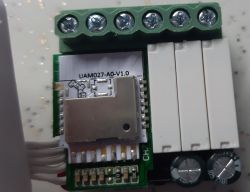 Smart device UAM027-A0-V1.0 with five screw connectors and three large white buttons.