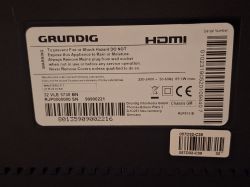 Technical label of a Grundig television with warning and specifications.