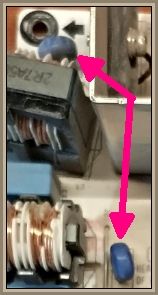 Close-up of electronic components with pink arrows pointing to specific elements.