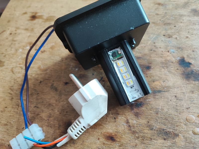 Open LED Device with Wires Open LED device with wires and plug on a wooden surface