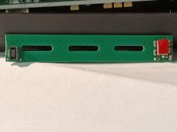 Green touch panel with slotted holes and red component on the right