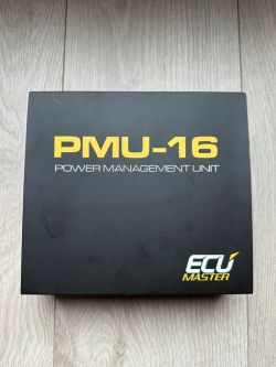 Black box labeled “PMU-16 Power Management Unit” with “ECU Master” logo on a wooden floor.