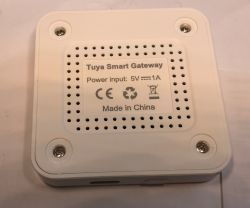 Tuya Smart Gateway - Top View White Tuya Smart Gateway with ventilation holes and power information.