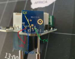 PCB with Pin Labels Close-up of a PCB with labeled pins: RX, TX, GND, VCC, and 3.3V.