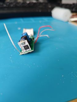 Tuya Electronic Module on a Blue Background Photo of a Tuya electronic module with visible components on a blue background.