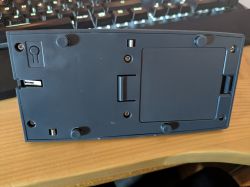 Bottom of a Plastic Device with Battery Compartment The bottom of a plastic electronic device with a battery compartment and rubber feet.