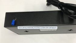 Bottom of a black metal enclosure with a power cable and a blue crimp terminal on a screw
