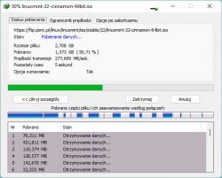 Ekran pobierania pliku Linux Mint 22 Cinnamon 64-bit z informacjami o postępie.