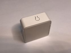 ATLO-SW1-TUYA Relay Module for Home Automation Small white ATLO-SW1-TUYA relay module on a white background, with a light bulb symbol on top of the case.