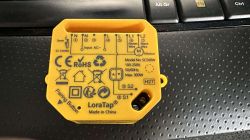 LoraTap SC500W Switch Module Yellow LoraTap SC500W module on a keyboard background.