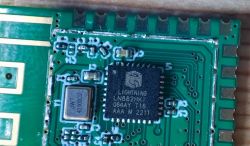 QFN-32 integrated circuit on a circuit board with visible pins and markings.