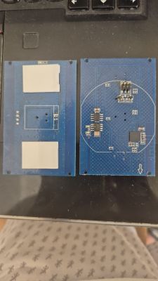 Two blue PCB modules with electronic components and contact pads