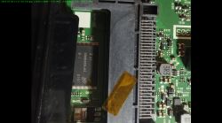Close-up of a TV's mainboard showing integrated circuits and electronic components.