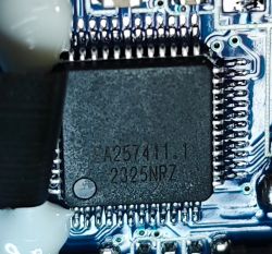 Microprocessor EA257411.1 on Camera Circuit Board Close-up of a microprocessor labeled EA257411.1 2325NRZ on a circuit board of a camera.