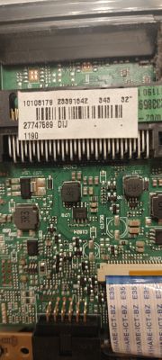 Electronic circuit board with barcode label and ribbon connectors Close-up of a circuit board with electronic components, connectors, and ribbon cable
