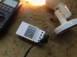 Sonoff POWR316D with a connected lamp and LCD display showing energy consumption.