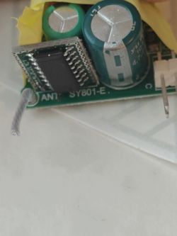 Close-up of a circuit board with electronic components, including capacitors and a module.
