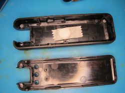 Disassembled black plastic housing Disassembled black plastic enclosure with masking tape inside