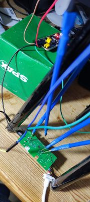 Flashing the BK7231N Circuit Board Close-up of a circuit board with wires connected to various points on a green background.