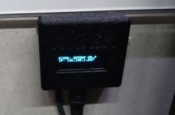 ESP8266 module with OLED screen showing KIOSK status and IP address