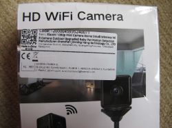 Xiaomi 1080p Mini WiFi Camera Packaging Packaging of a mini spy camera labeled HD WiFi Camera with a product and manufacturer information sticker.