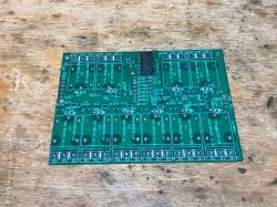 Printed circuit board with markings and soldering points.
