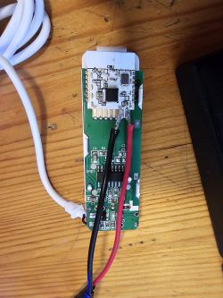 Electronic module with connected wires on a wooden table.