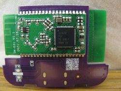 Close-up of a green printed circuit board with an integrated circuit.