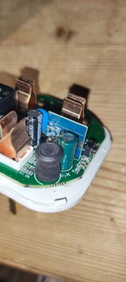 Interior of Device with Visible Circuit Board Close-up of the interior of an electronic device with a visible printed circuit board and components.