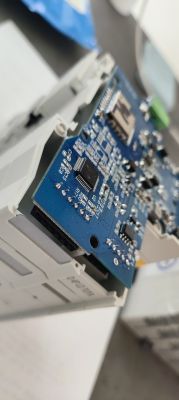 Close-up of a device’s circuit board with Tuya MCU chip and side pins visible.
