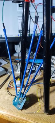 Wiring connections with an electronic module on a desk.