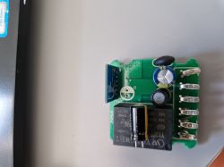 Electronics module with capacitors, relay, and screw terminals on a PCB