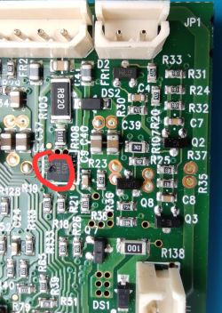 Close-up of PCB with marked chip showing dark residue or burn marks