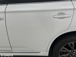 White car door with visible handle and wheel.