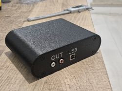 Black device enclosure with RCA “OUT” jacks and a USB port on the front panel
