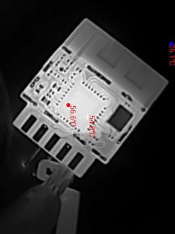 Thermal image of an electronic circuit board with temperature markings.