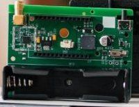 Circuit Board with Power Supply Module and Antenna Connector Green circuit board with various electronic components and a connector for an external antenna.