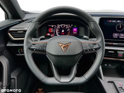 Steering wheel with Cupra logo and digital instrument cluster inside a car