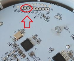 Close-up of a circuit board with highlighted TXD and RXD holes.