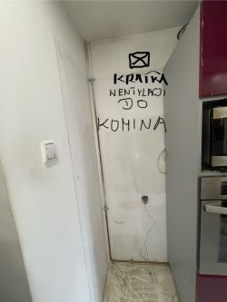 Szafa kuchenna z widocznym napisem o kratce wentylacyjnej.