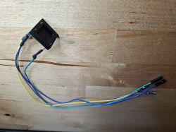 U-Flame sensor with connected jumper wires on a wooden surface