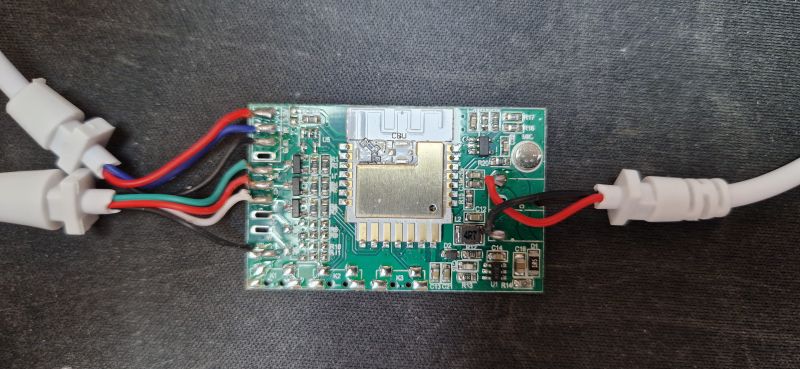CBU module with connected wires on a dark fabric background